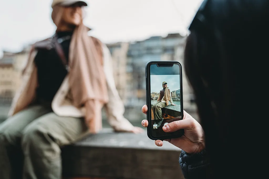 Person taking a photo with a smartphone?>
